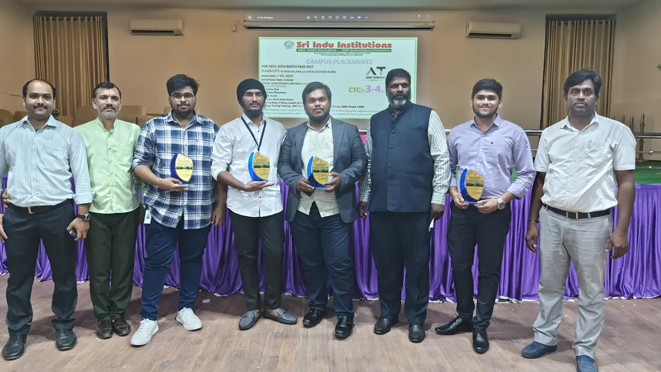 A group holding recognition trophies at Sri Indu Institutions
