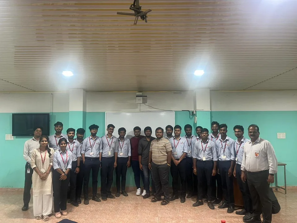 Students and college representatives gathered for a group photograph in a classroom