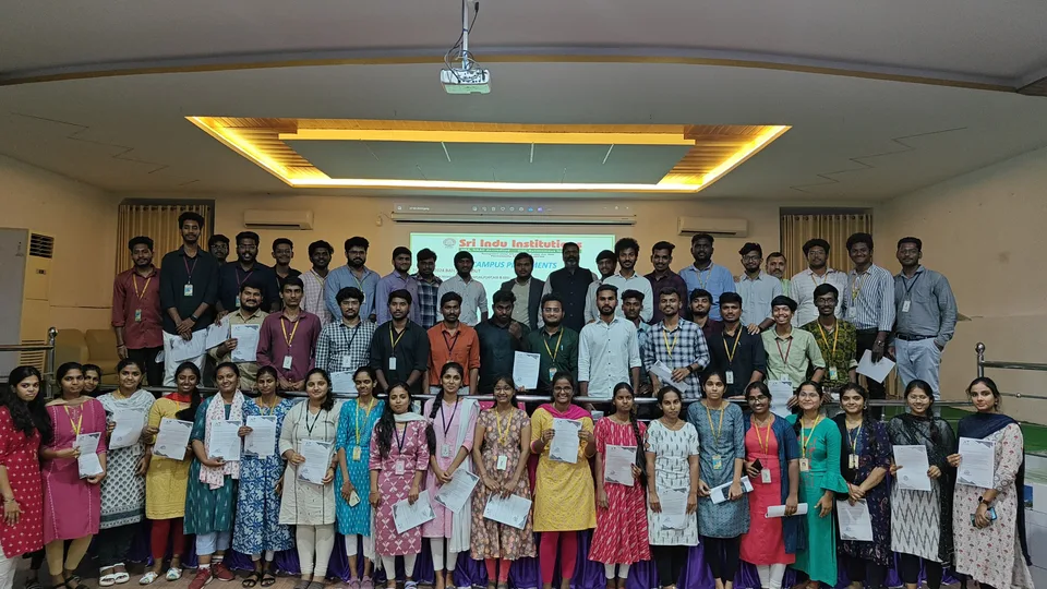 A large group of students holding certificates at a Sri Indu Institutions campus placement event