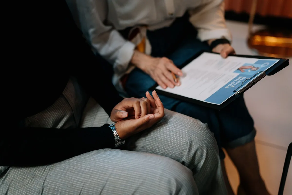 A recruiter and candidate discussing a printed CV during an interview.